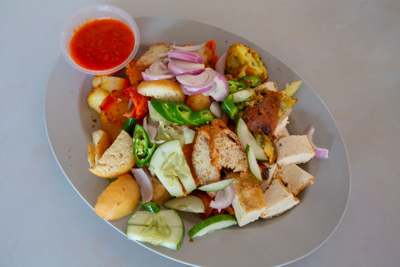 Assortment of fritters,
                potatoes, cuttlefish, eggs, tofu, and fishcake, topped with fresh cucumber and onion