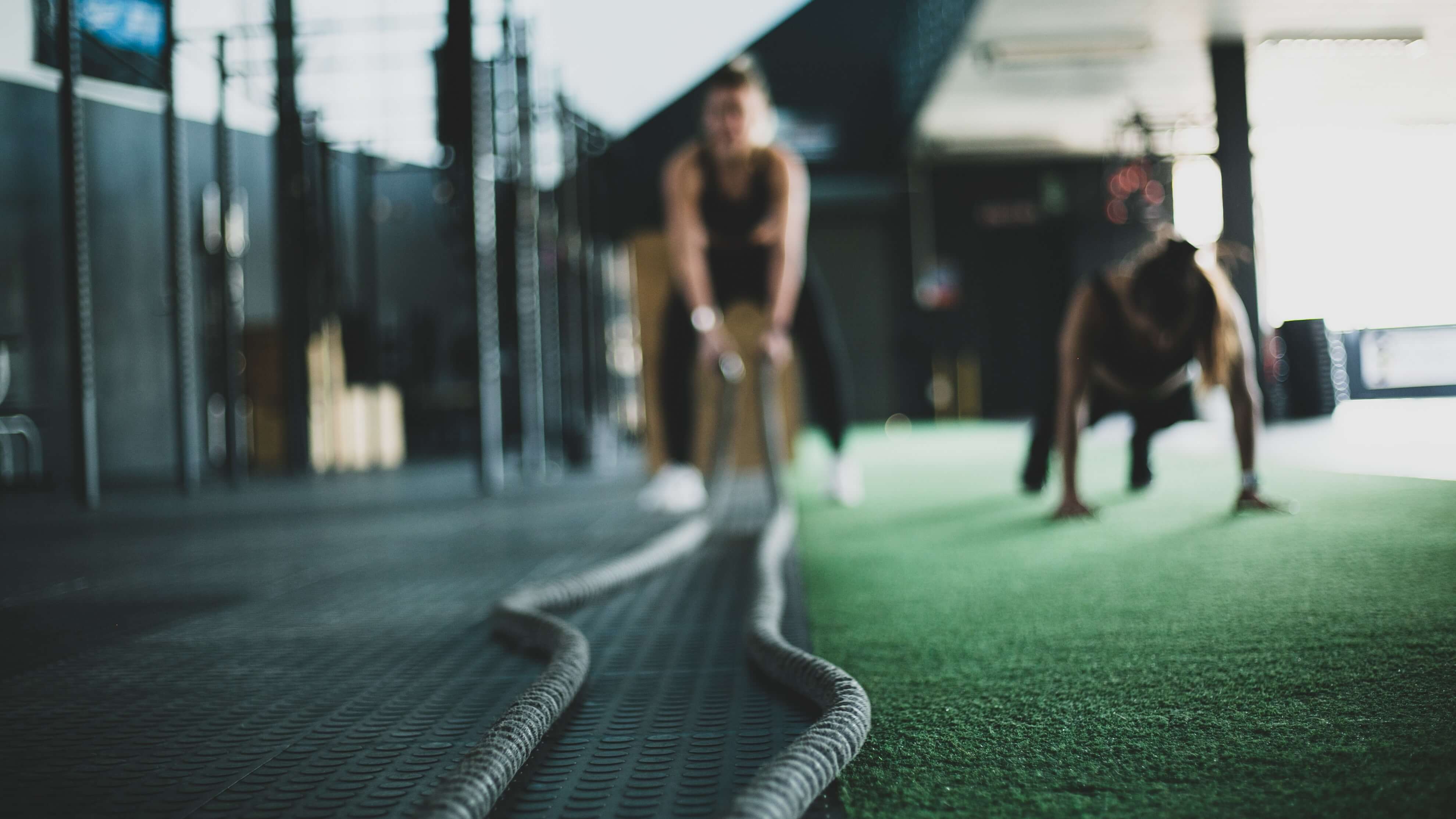 Women battling ropes and doing pushups