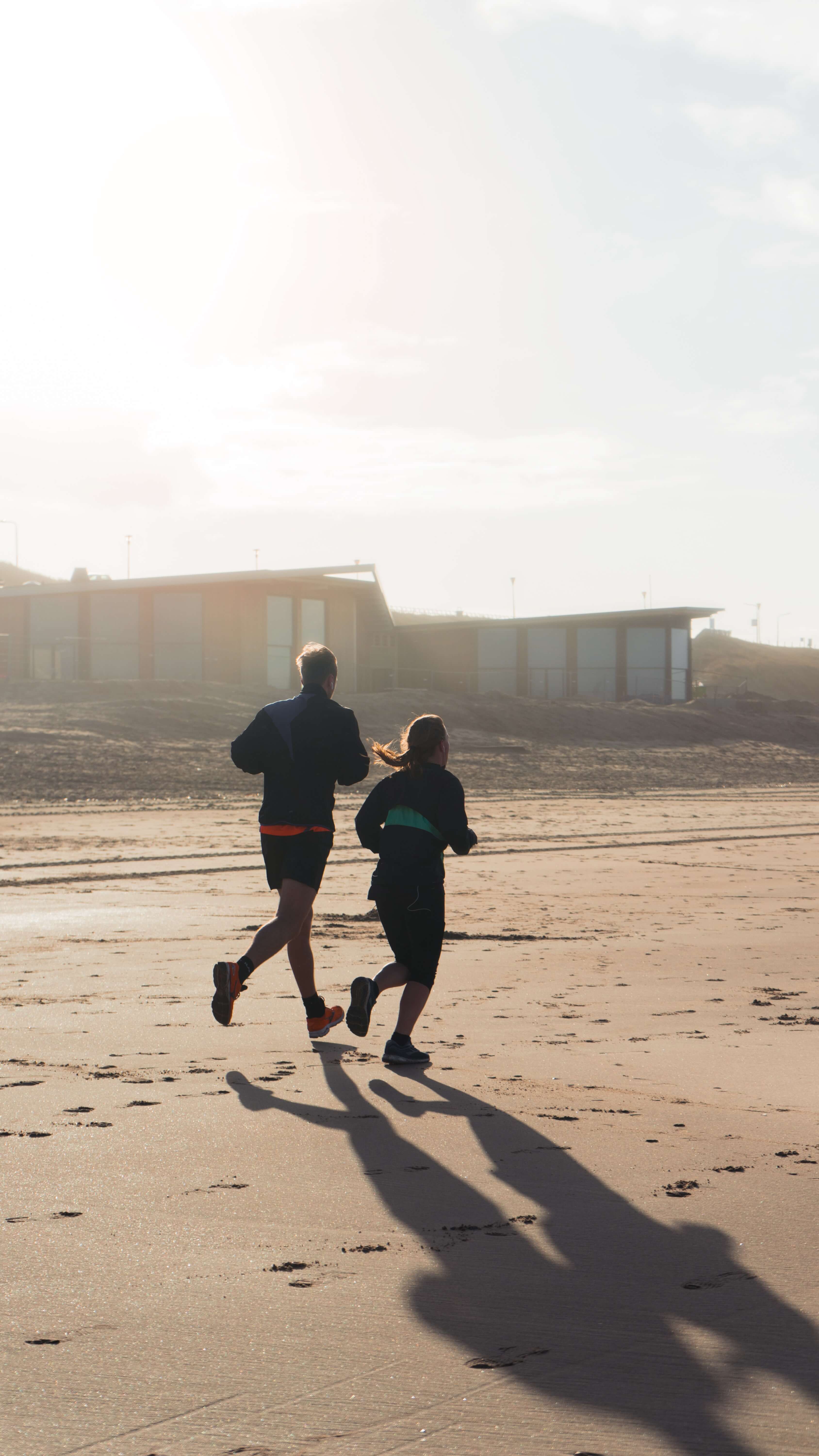 A man and a woman running as an exercise