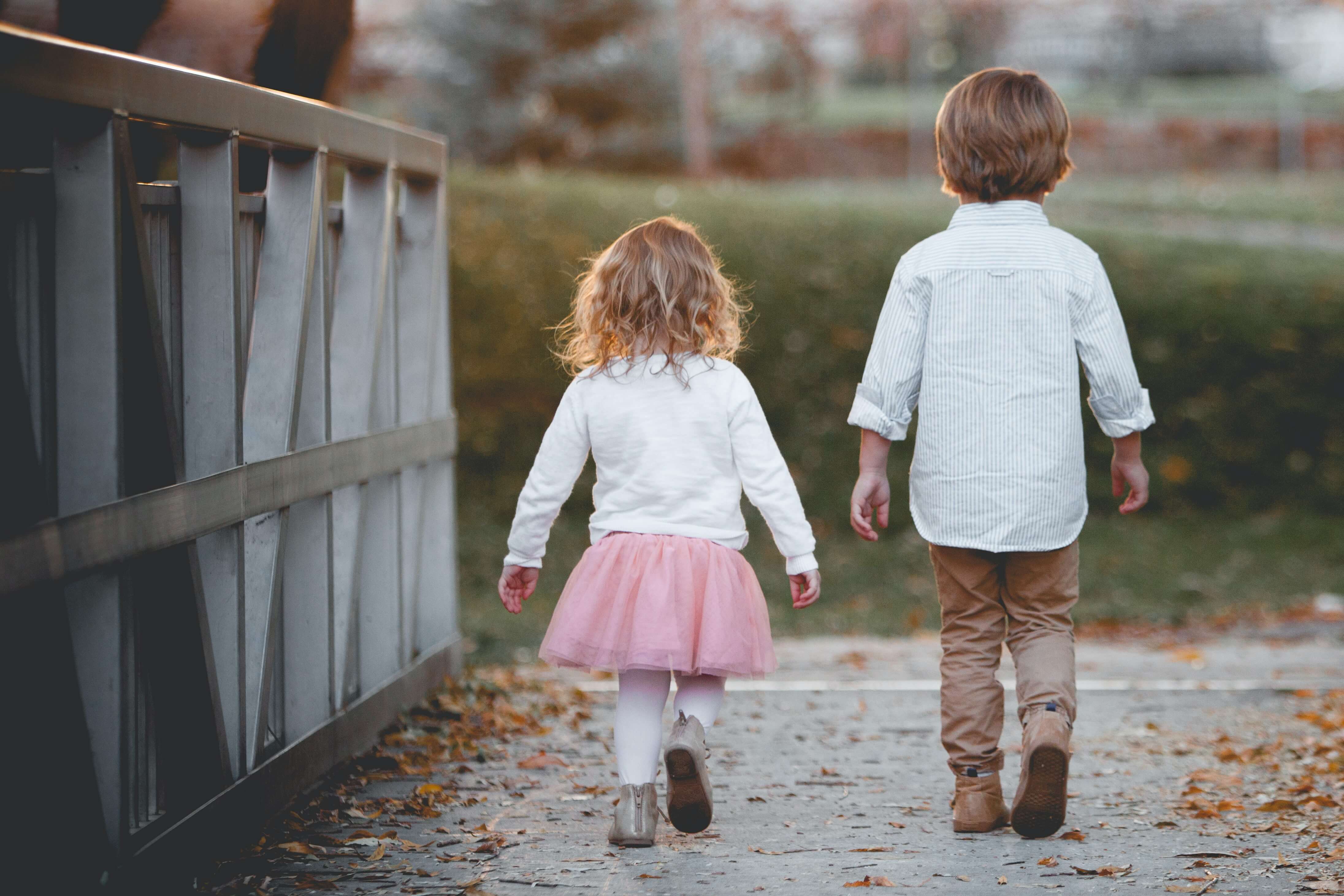 A little boy and little girl walking