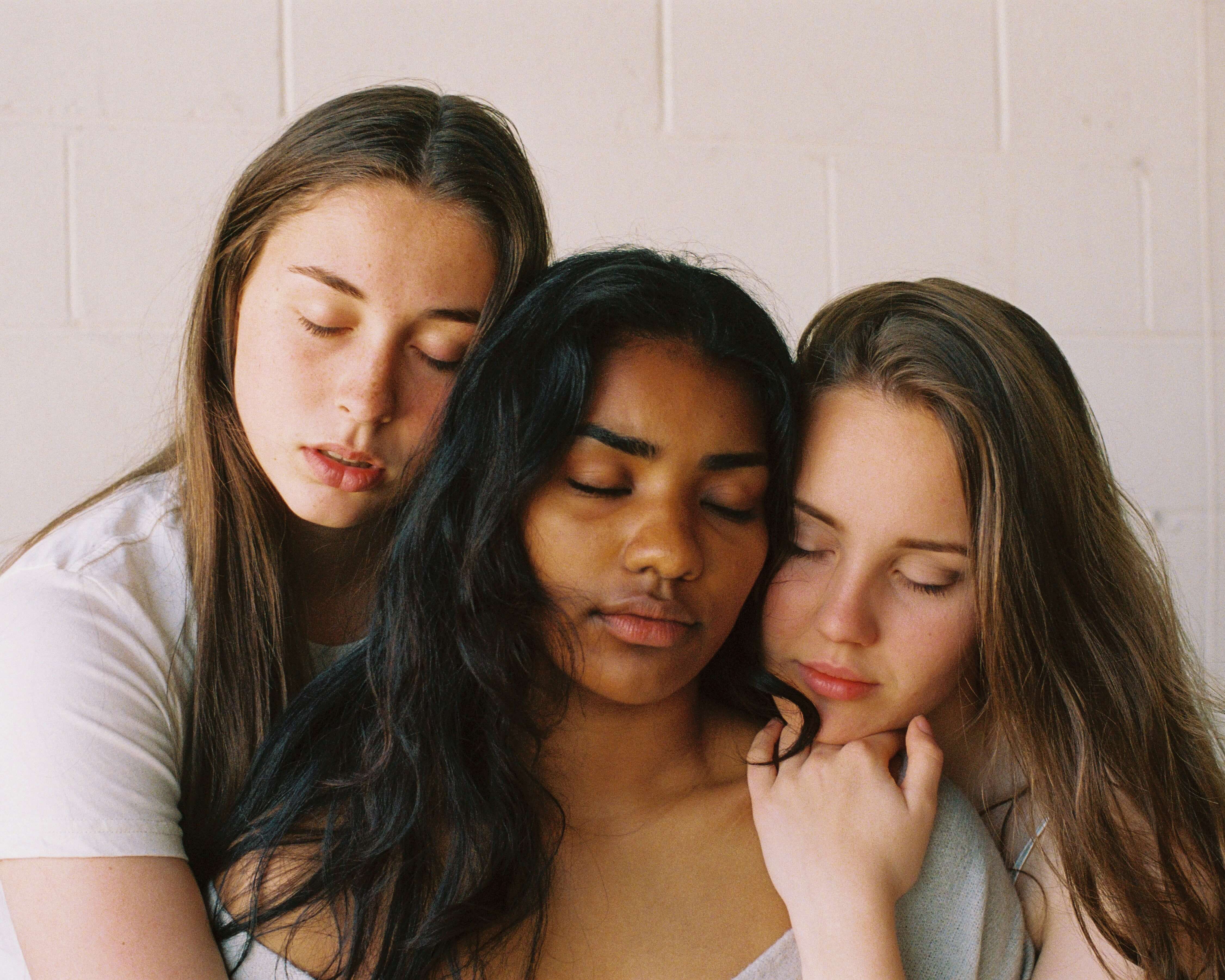 3 diverse women side by side, with their eyes closed