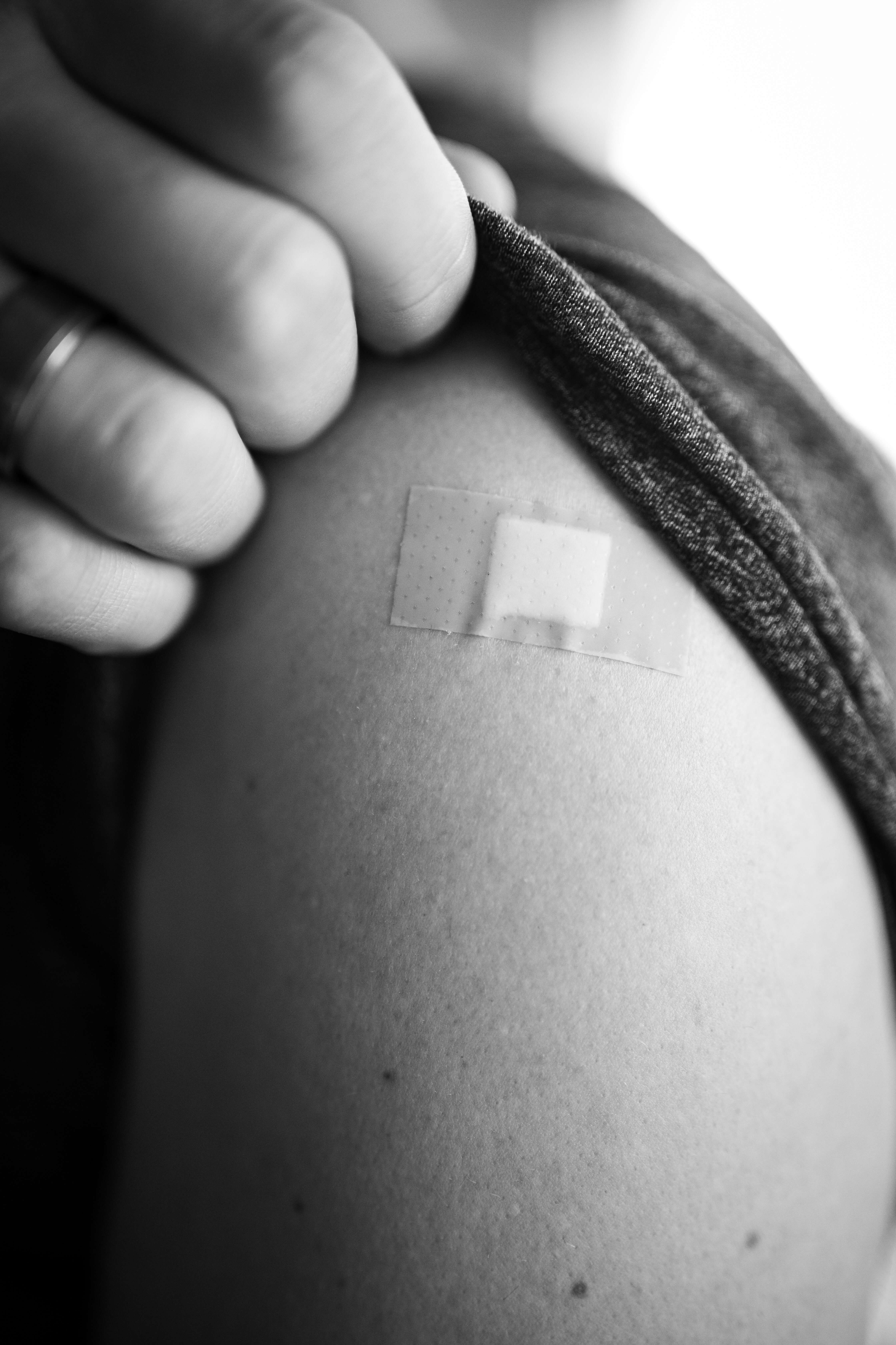 Vaccination shot on the shoulder, covered with band-aid